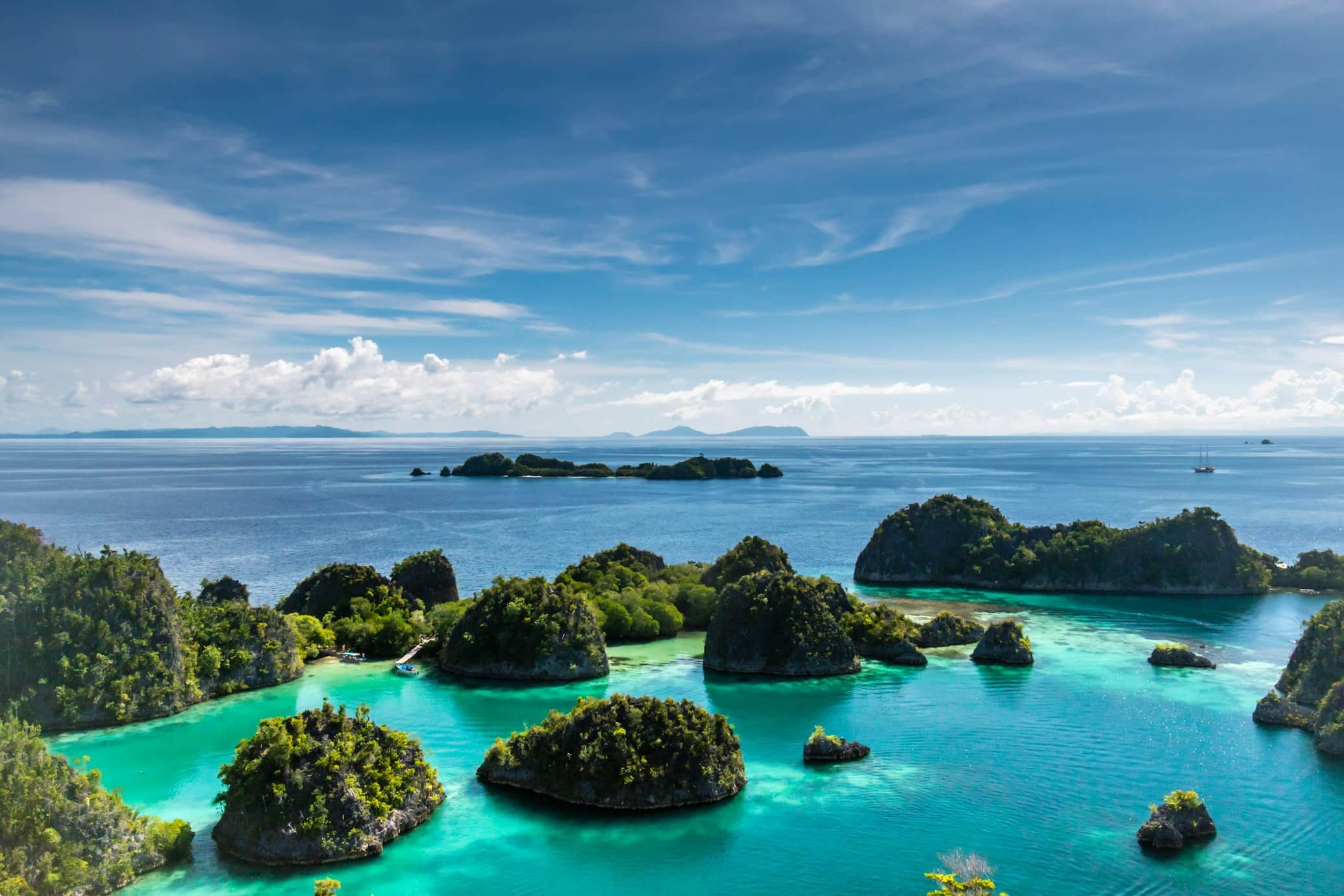 Turquoise water and islands beneath a calm sky